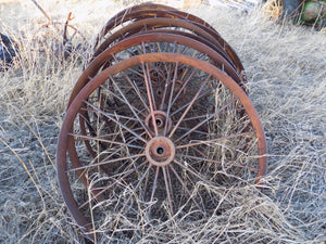 25 year collection of antique  steel farm equipment wheels